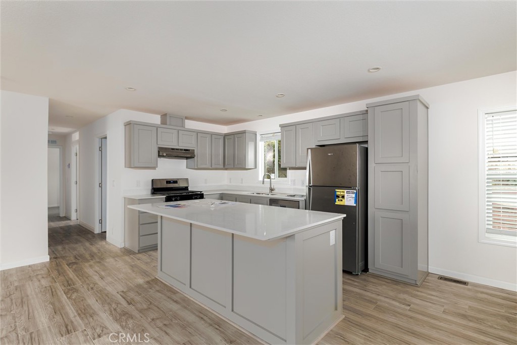 1255 Orcutt Road, Unit A11 San Luis Obispo, CA 93401 - Photo 12 of 22 a kitchen with a sink a refrigerator and cabinets