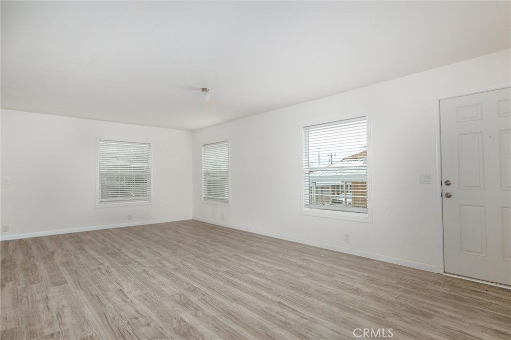 1255 Orcutt Road, Unit A11 San Luis Obispo, CA 93401 - Photo 13 of 22 a view of an empty room with wooden floor and a window