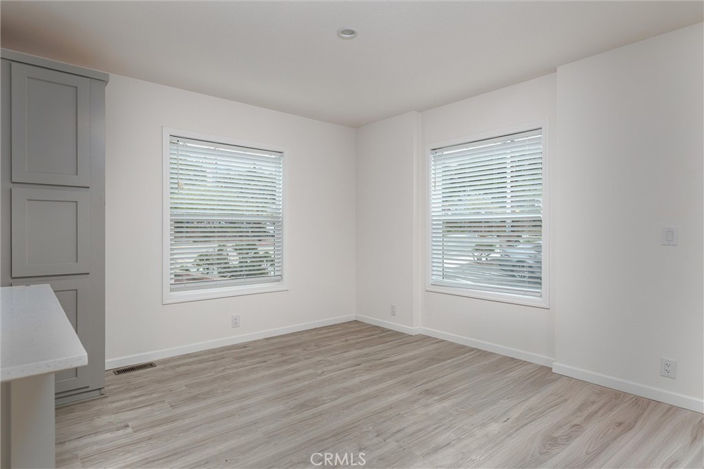 1255 Orcutt Road, Unit A11 San Luis Obispo, CA 93401 - Photo 18 of 22 a view of an empty room with wooden floor and a window