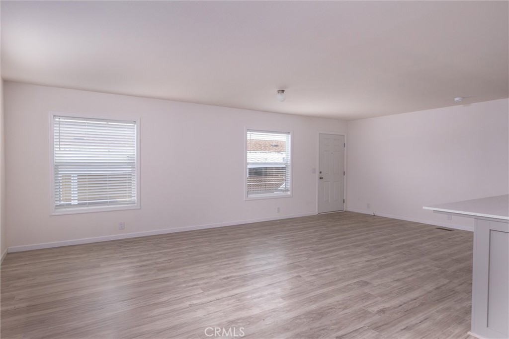 1255 Orcutt Road, Unit A11 San Luis Obispo, CA 93401 - Photo 20 of 22 a view of an empty room with wooden floor and a window