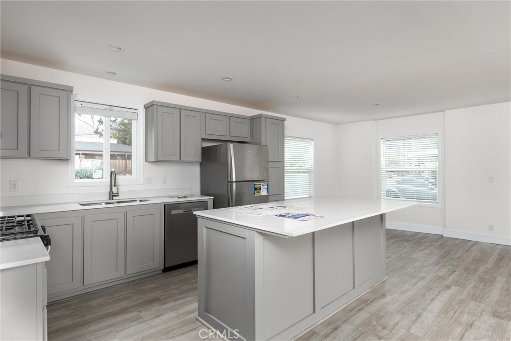 1255 Orcutt Road, Unit A11 San Luis Obispo, CA 93401 - Photo 10 of 22 a kitchen with a sink a stove a refrigerator and white cabinets
