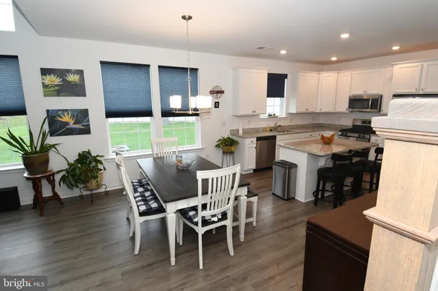 a view of kitchen with cabinets table and chairs