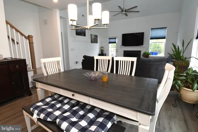a view of dining room with furniture wooden floor and mirror