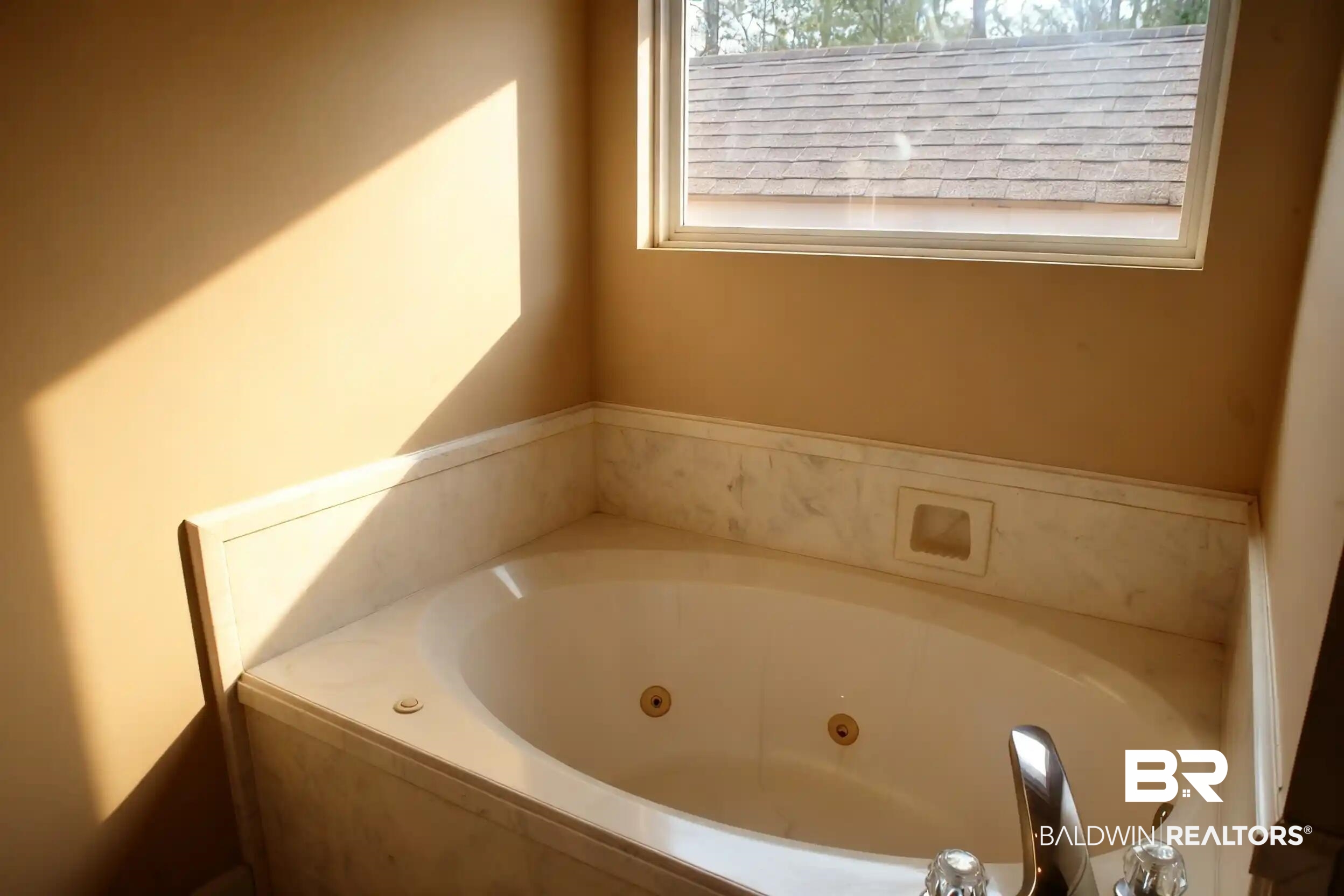 8008 Patricks Landing Road Bay Minette, AL 36507 - Photo 14 of 33 Jetted soaking tub with a surrounding stone-finish deck and integrated shelving