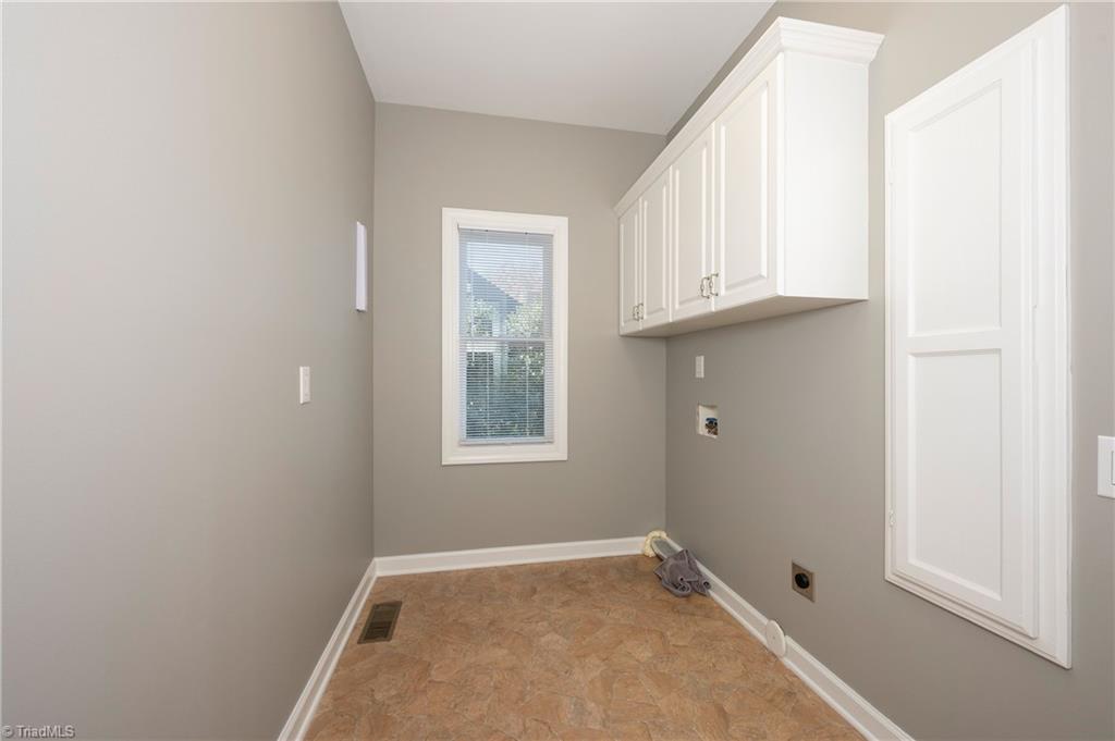1851 Waterford Pointe Road Lexington, NC 27292 - Photo 22 of 49 Main level laundry room with cabinets, handing bar and an ironing board