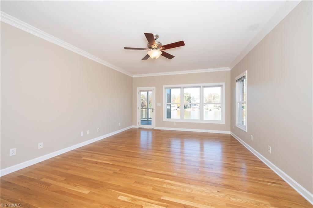 1851 Waterford Pointe Road Lexington, NC 27292 - Photo 27 of 49 Spacious Primary bedroom with HW floors, ceiling fan and a walk out door to the screened porch