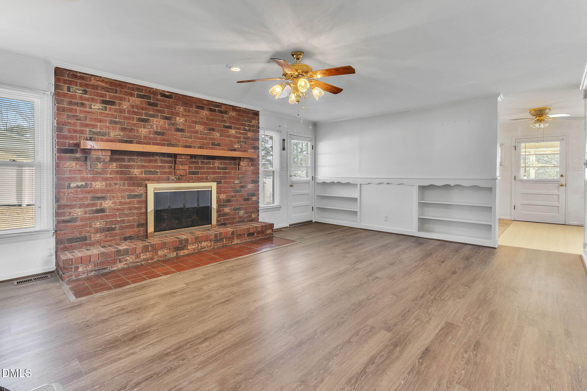 1828 Fletchers Chapel Road Durham, NC 27703 - Photo 11 of 36 wooden floor in an empty room with a fireplace