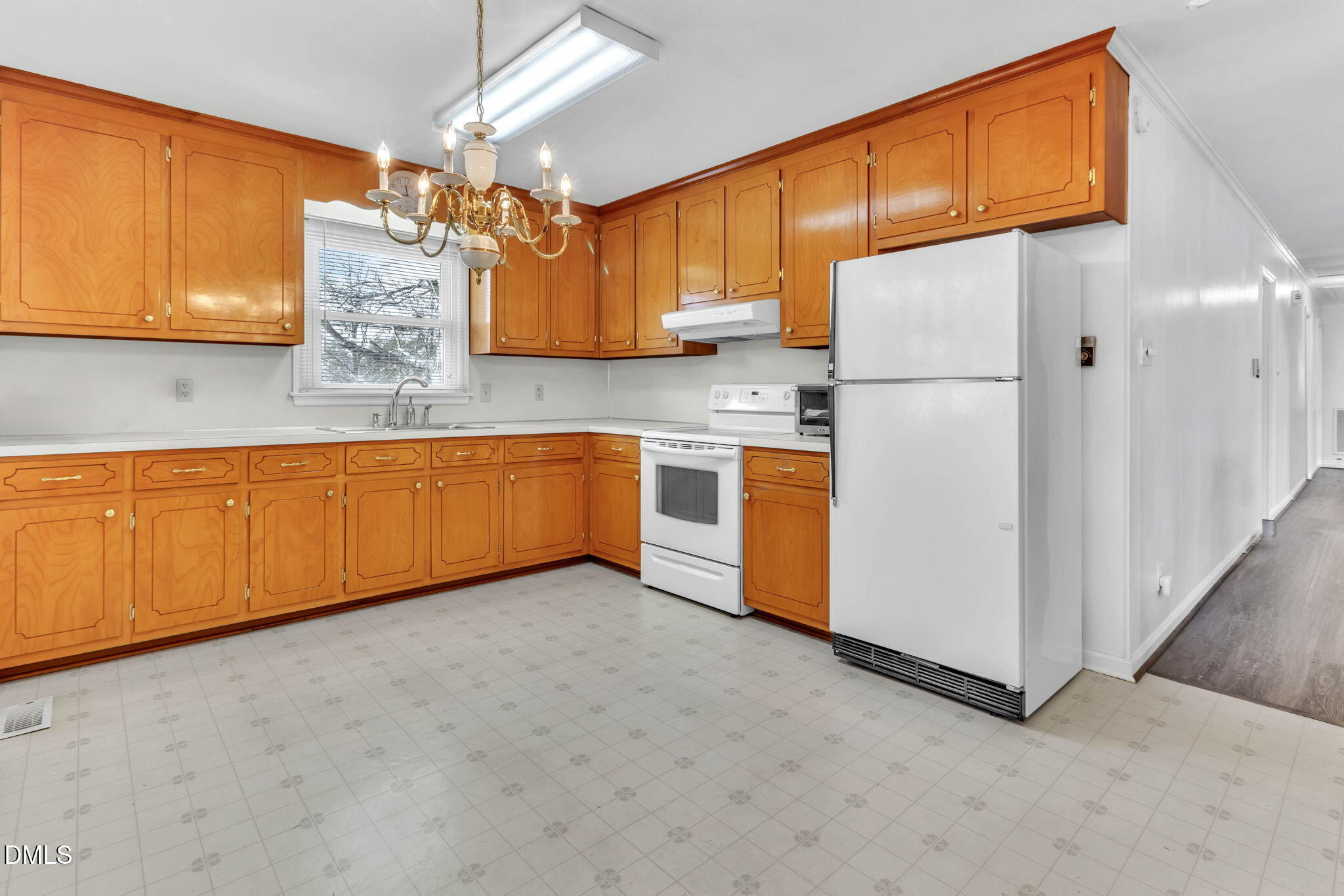 1828 Fletchers Chapel Road Durham, NC 27703 - Photo 3 of 36 a kitchen with stainless steel appliances granite countertop a refrigerator a sink dishwasher and wooden cabinets with wooden floor