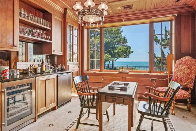 a view of a dining room with furniture a chandelier and wooden floor