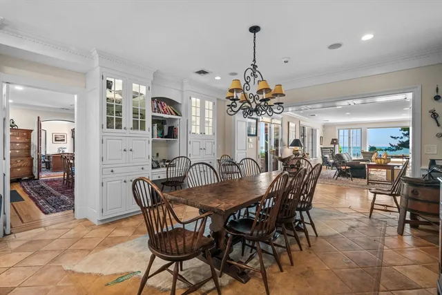 a view of a dining room and livingroom with furniture wooden floor a chandelier