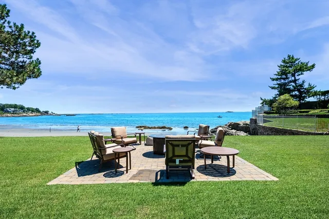 a view of a hallway to a livingroom with furniture