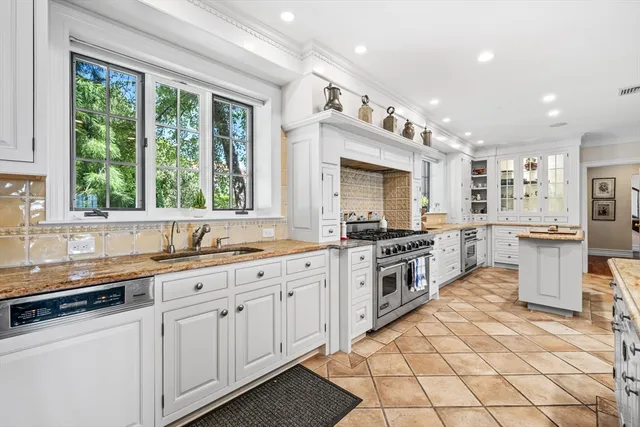a kitchen with granite countertop a sink cabinets and window