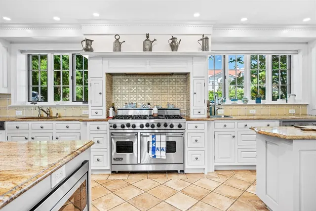 a kitchen with stainless steel appliances granite countertop a stove and a sink