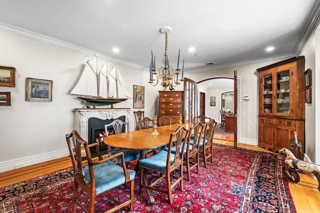 a dining room with furniture a chandelier and wooden floor
