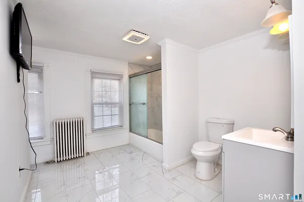a bathroom with a bathtub toilet and a shower