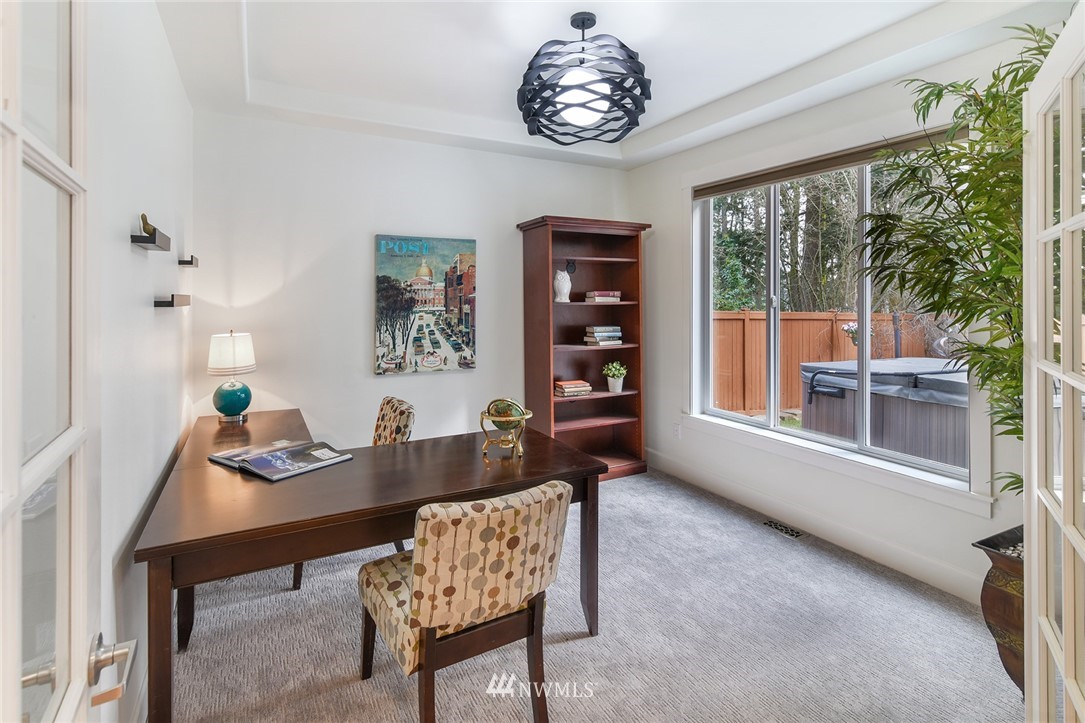 22548 5th Place West Bothell, WA 98021 - Photo 12 of 38 a dining room with furniture a rug a potted plant and a chandelier