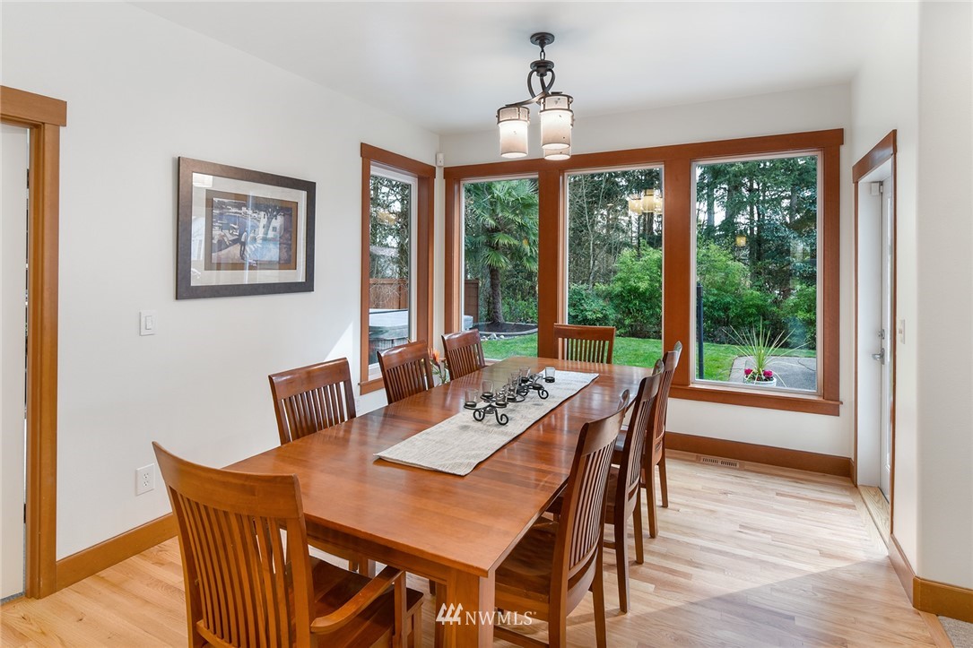 22548 5th Place West Bothell, WA 98021 - Photo 13 of 38 a view of a dining room with furniture window and wooden floor