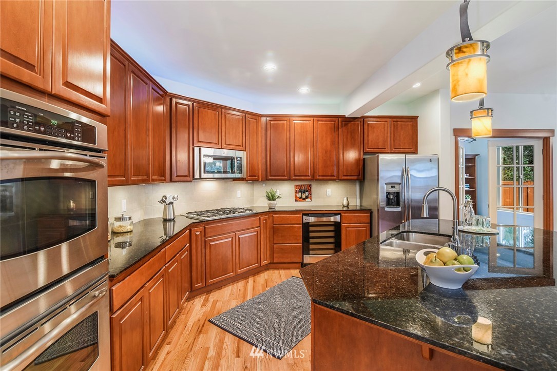 22548 5th Place West Bothell, WA 98021 - Photo 20 of 38 a kitchen with granite countertop a stove sink and cabinets