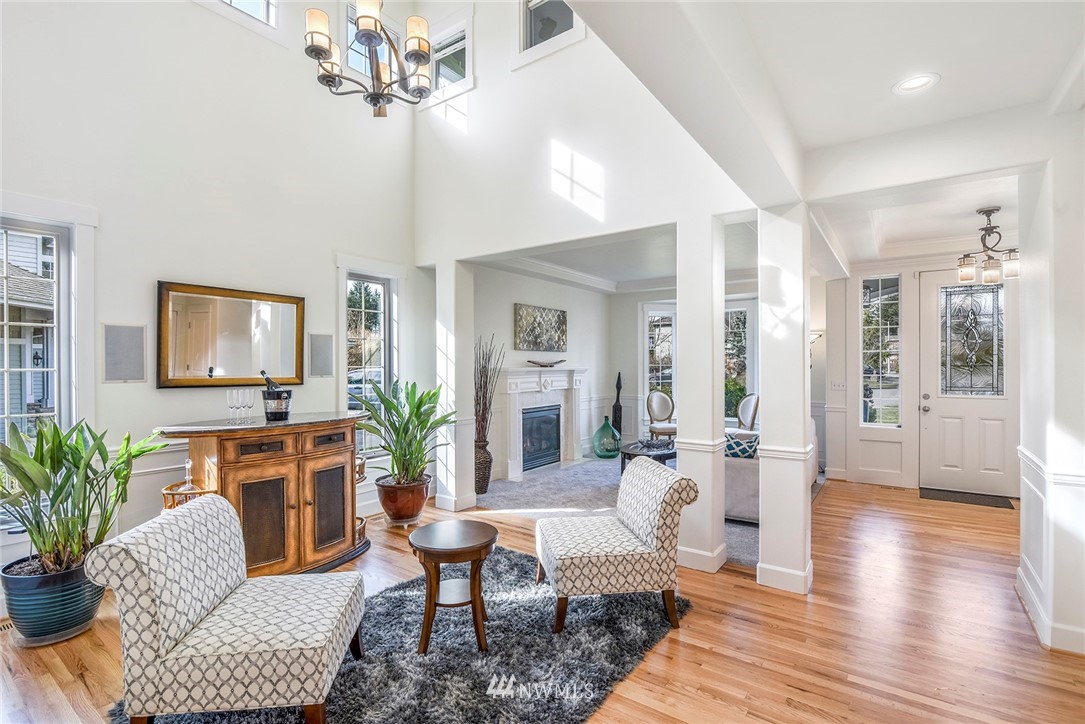 22548 5th Place West Bothell, WA 98021 - Photo 22 of 38 a living room with furniture a chandelier and a wooden floor