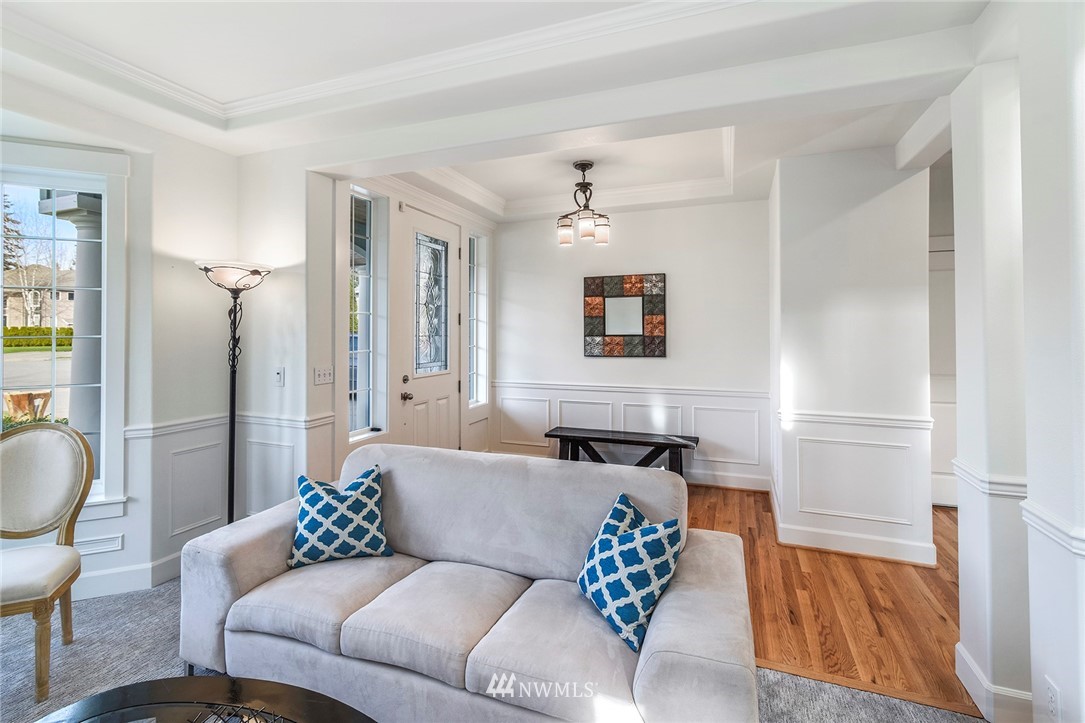 22548 5th Place West Bothell, WA 98021 - Photo 24 of 38 a living room with furniture and a chandelier