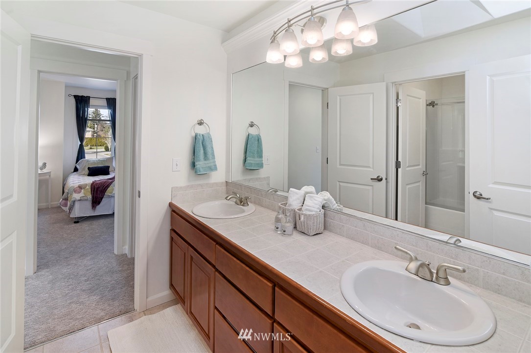 22548 5th Place West Bothell, WA 98021 - Photo 37 of 38 a en suite bathroom with a double vanity sink and a mirror