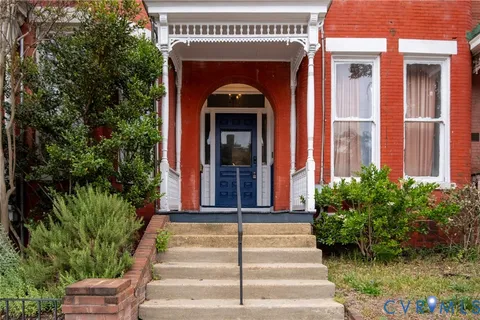 a front view of a house with potted plants