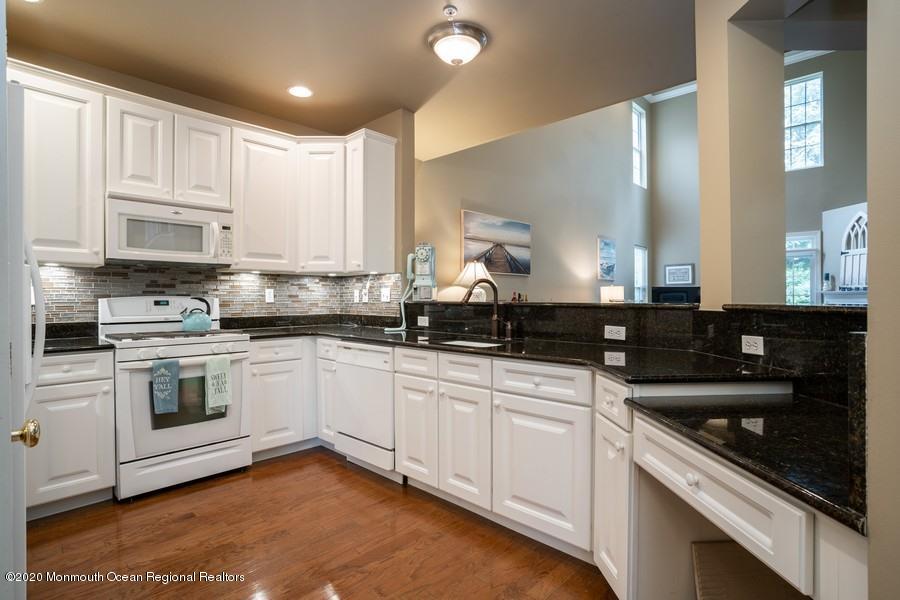804 Abby Road Middletown, NJ 07748 - Photo 2 of 19 a kitchen with a sink stove and cabinets