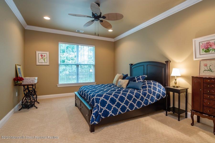 804 Abby Road Middletown, NJ 07748 - Photo 11 of 19 a bedroom with a bed and a table lamp
