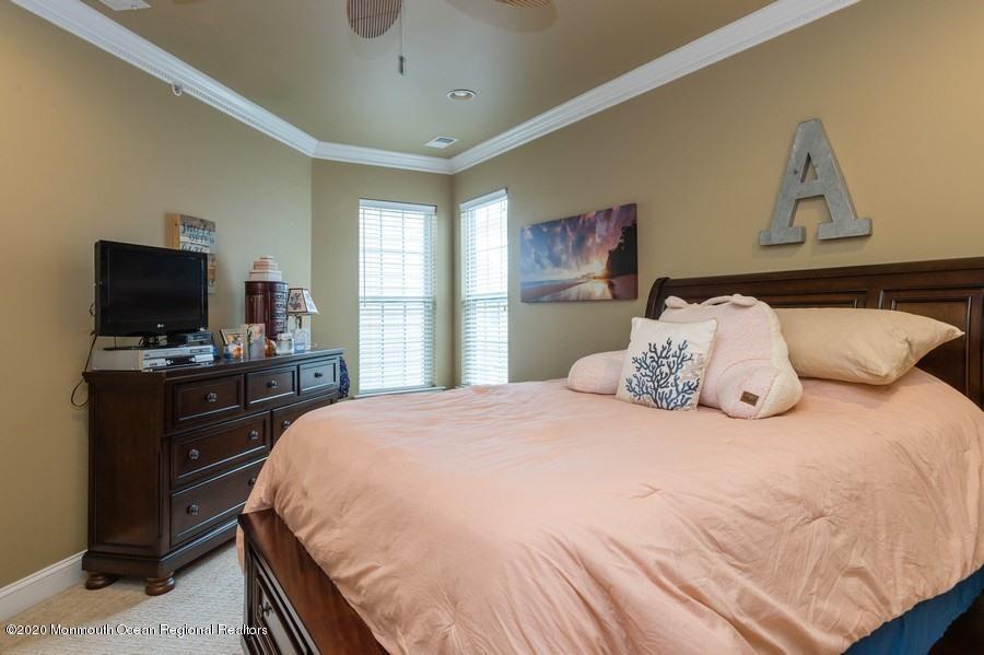 804 Abby Road Middletown, NJ 07748 - Photo 12 of 19 a bedroom with a bed and a flat screen tv