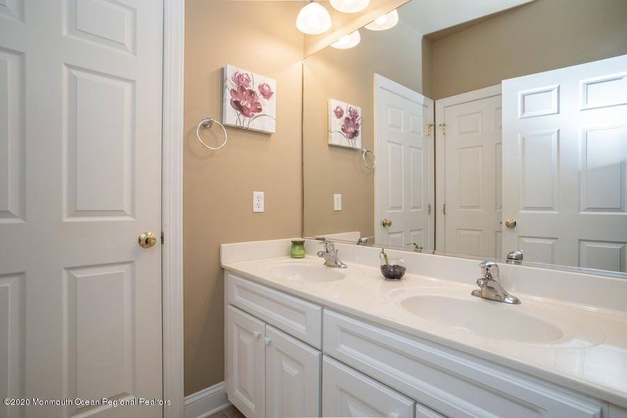804 Abby Road Middletown, NJ 07748 - Photo 15 of 19 a bathroom with a sink and a mirror