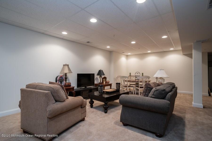 804 Abby Road Middletown, NJ 07748 - Photo 16 of 19 a living room with furniture and a flat screen tv