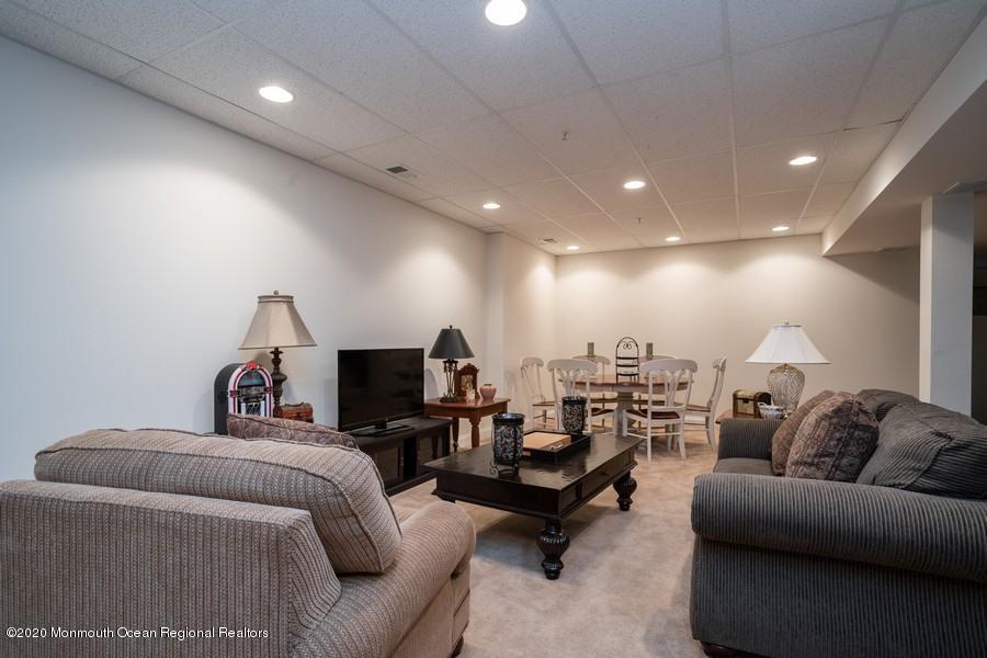 804 Abby Road Middletown, NJ 07748 - Photo 17 of 19 a living room with furniture and a flat screen tv