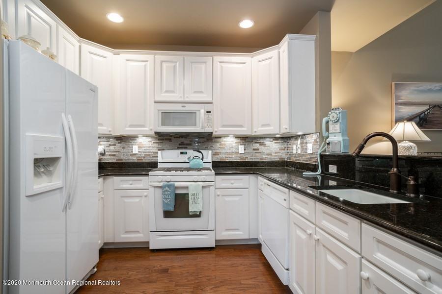 804 Abby Road Middletown, NJ 07748 - Photo 3 of 19 a kitchen with stainless steel appliances granite countertop grey cabinets a sink a stove a refrigerator and white cabinets