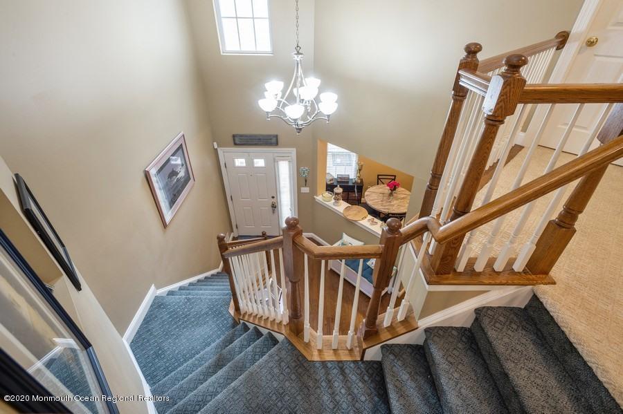 804 Abby Road Middletown, NJ 07748 - Photo 10 of 19 a view of an entryway wooden floor and chandelier