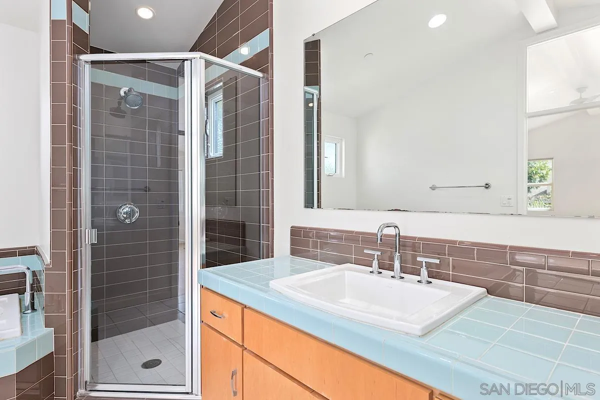 140 Range Street Encinitas, CA 92024 - Photo 25 of 51 a bathroom with a shower sink and mirror