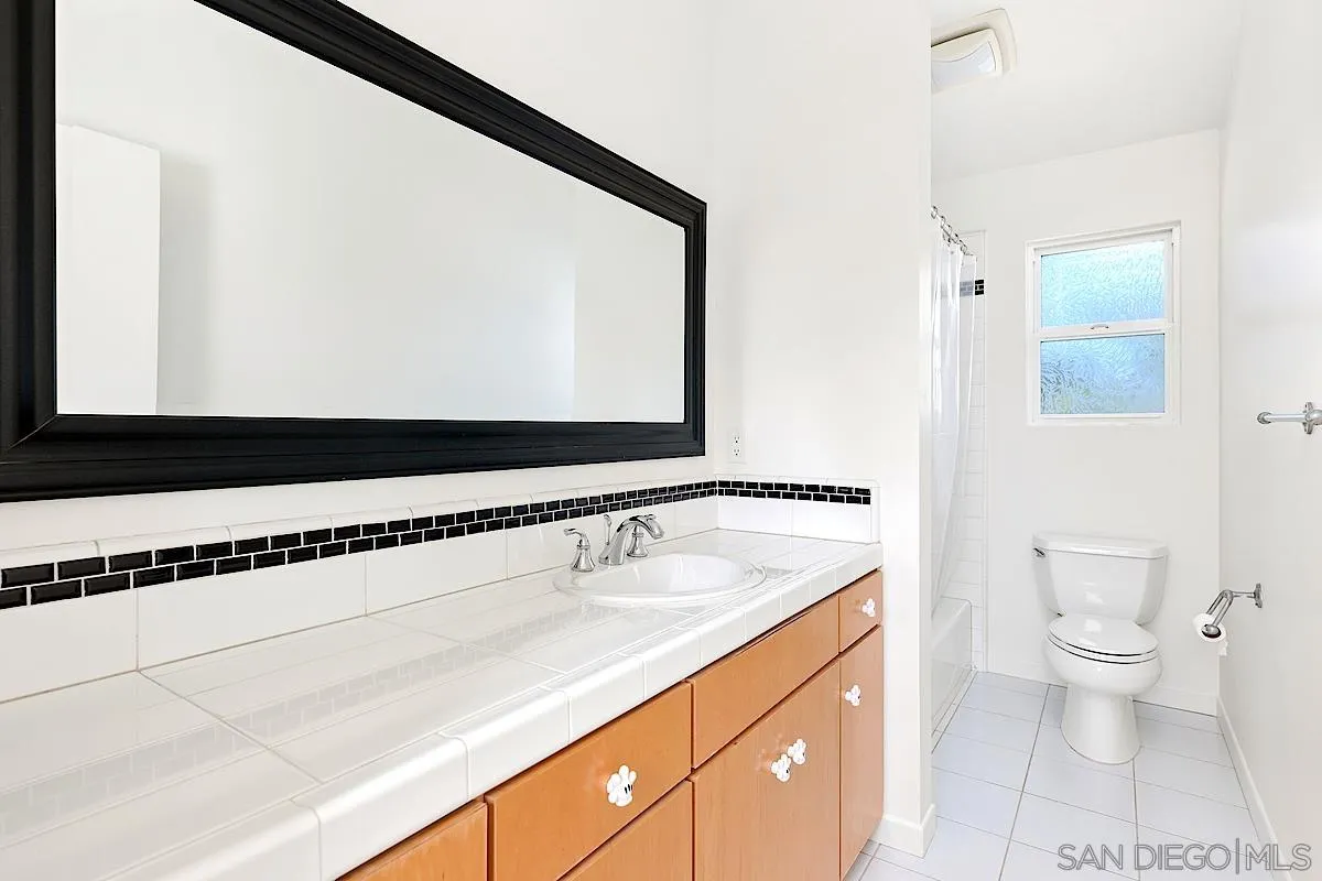 140 Range Street Encinitas, CA 92024 - Photo 31 of 51 a bathroom with a sink a toilet and a mirror