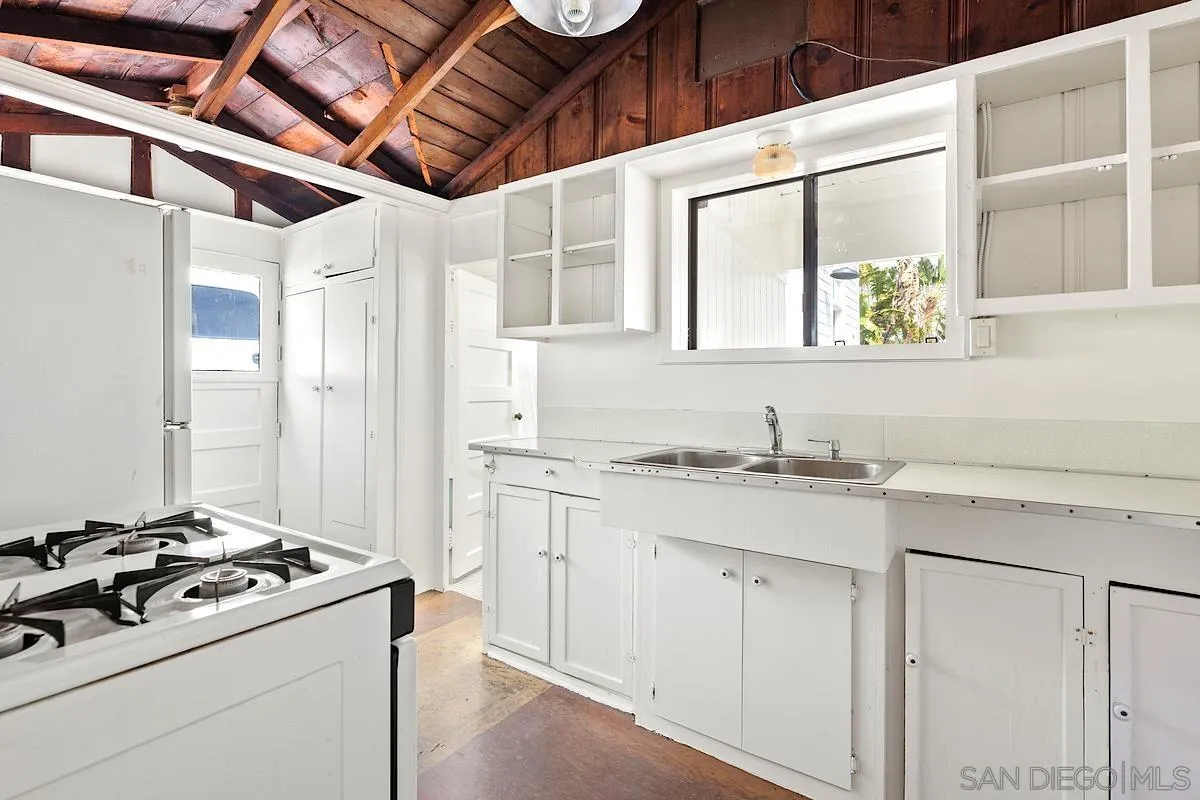 140 Range Street Encinitas, CA 92024 - Photo 43 of 51 a kitchen with a stove a sink and a refrigerator