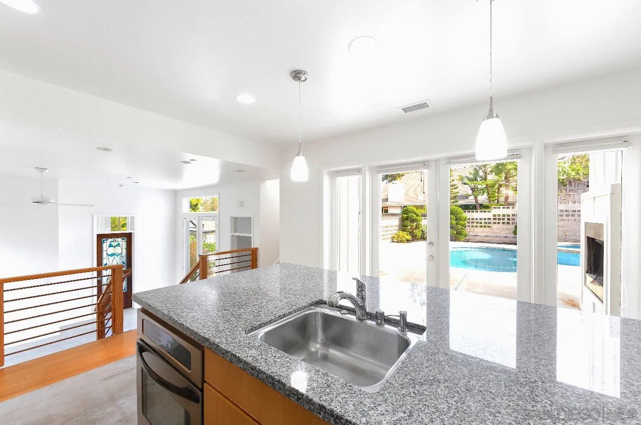 140 Range Street Encinitas, CA 92024 - Photo 7 of 51 a kitchen with granite countertop a sink a counter top space and living room view
