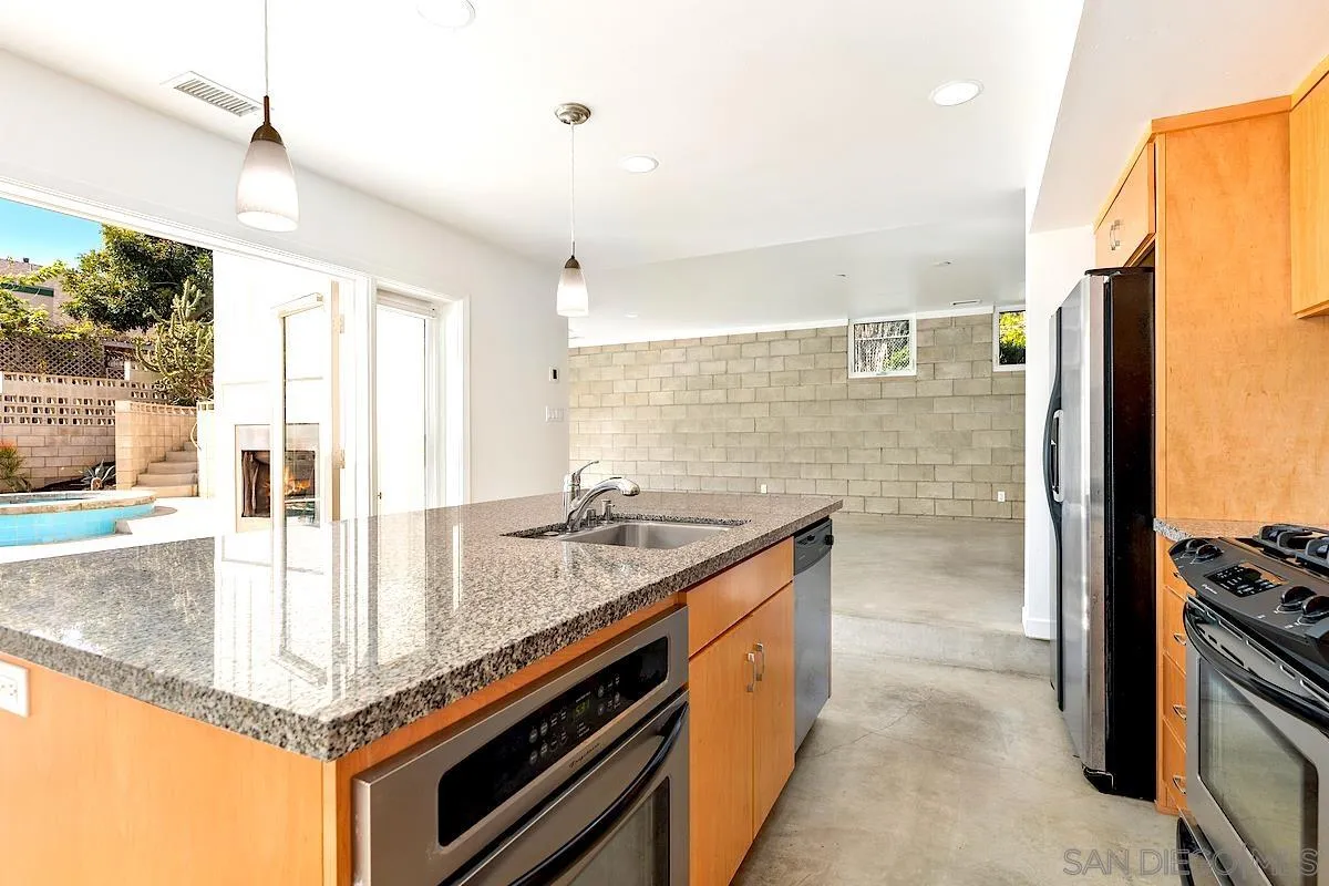 140 Range Street Encinitas, CA 92024 - Photo 8 of 51 a kitchen with stainless steel appliances granite countertop a sink and a refrigerator