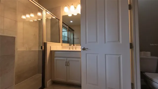 a bathroom with a sink vanity and a mirror