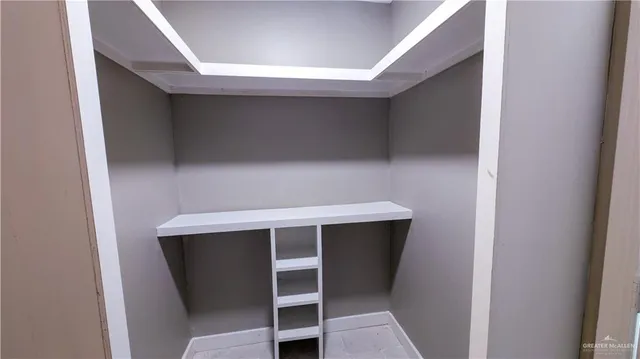 a bathroom with a sink and mirror with shower