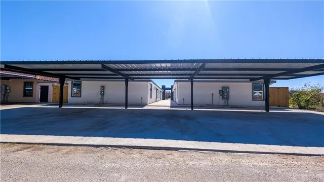 an empty room with wooden floor and a fireplace