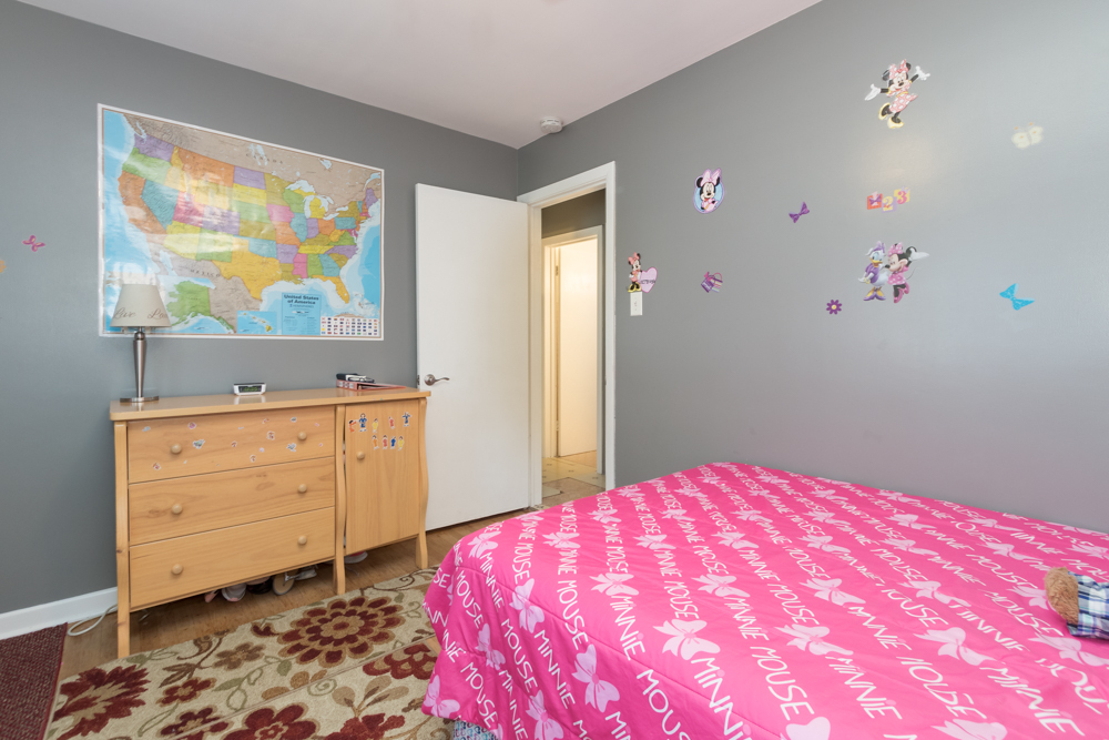 6204 35th Street Berwyn, IL 60402 - Photo 8 of 30 a bedroom with a bed and a flat screen tv