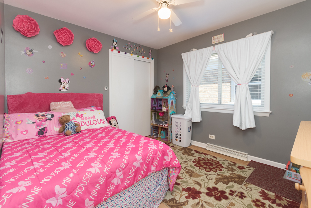 6204 35th Street Berwyn, IL 60402 - Photo 9 of 30 a bedroom with a bed and a dresser
