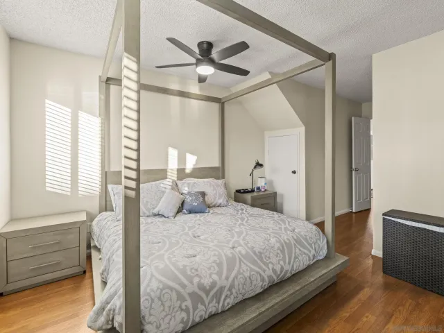 a bedroom with a bed and a ceiling fan