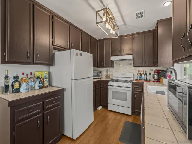 a kitchen with a refrigerator and a sink