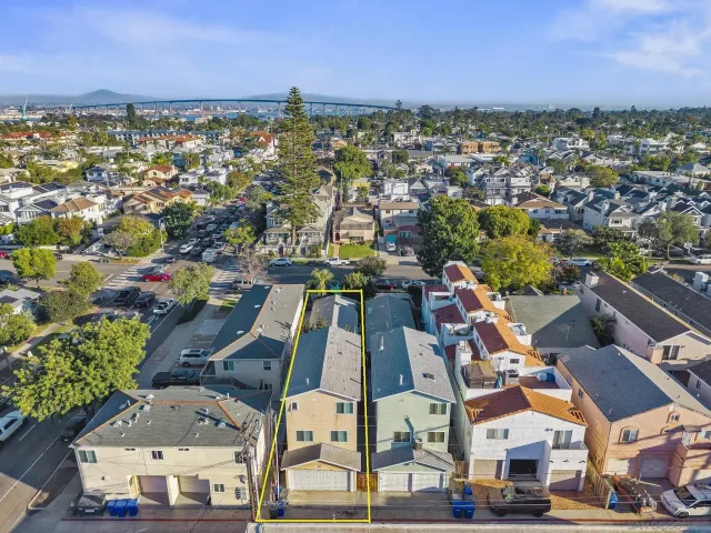 an aerial view of residential houses with outdoor space