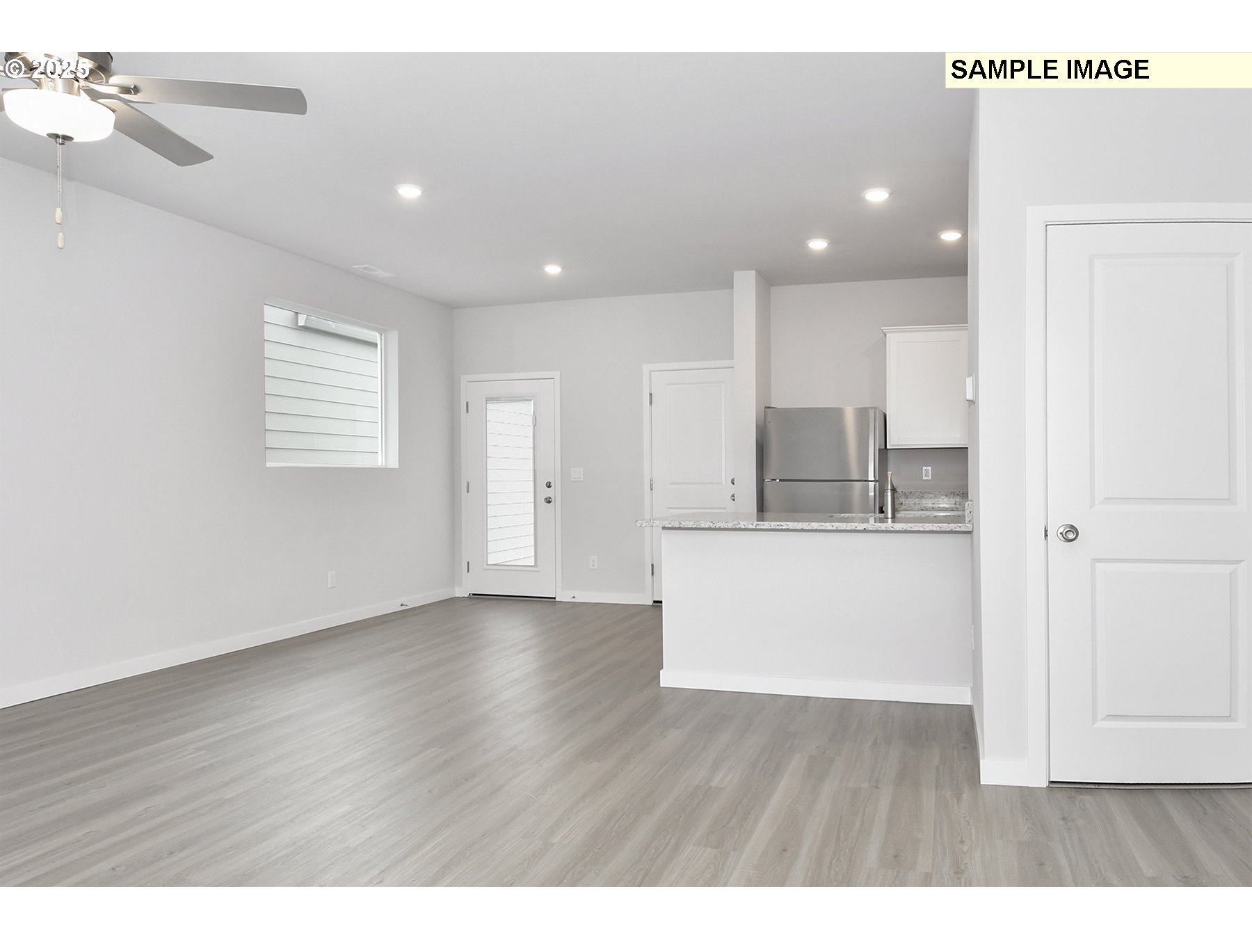 1285 Parkside Avenue Woodburn, OR 97071 - Photo 4 of 15 a view of kitchen with center island wooden floor and windows
