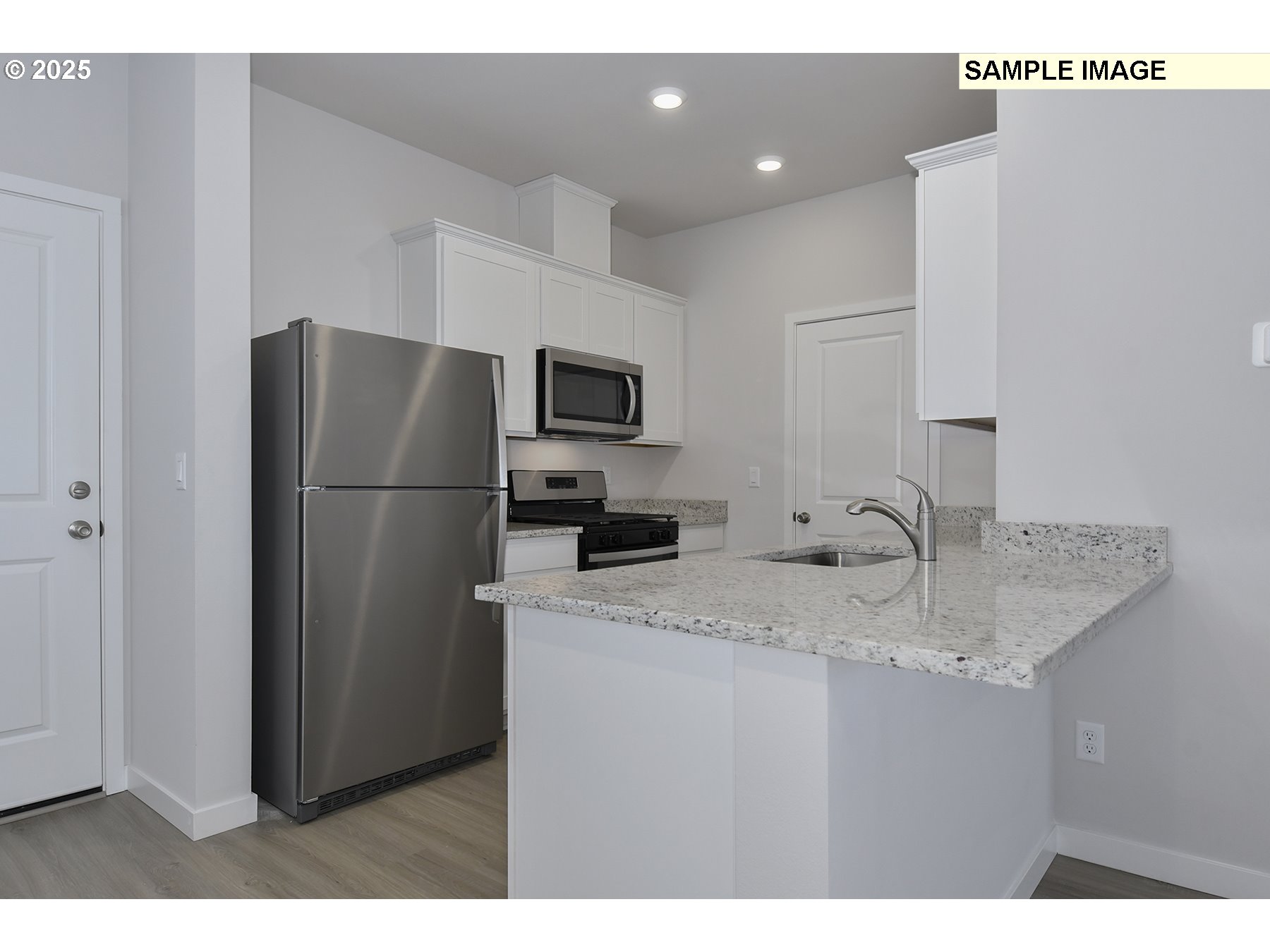 1285 Parkside Avenue Woodburn, OR 97071 - Photo 5 of 15 a kitchen with stainless steel appliances granite countertop a refrigerator a sink and a granite counter tops