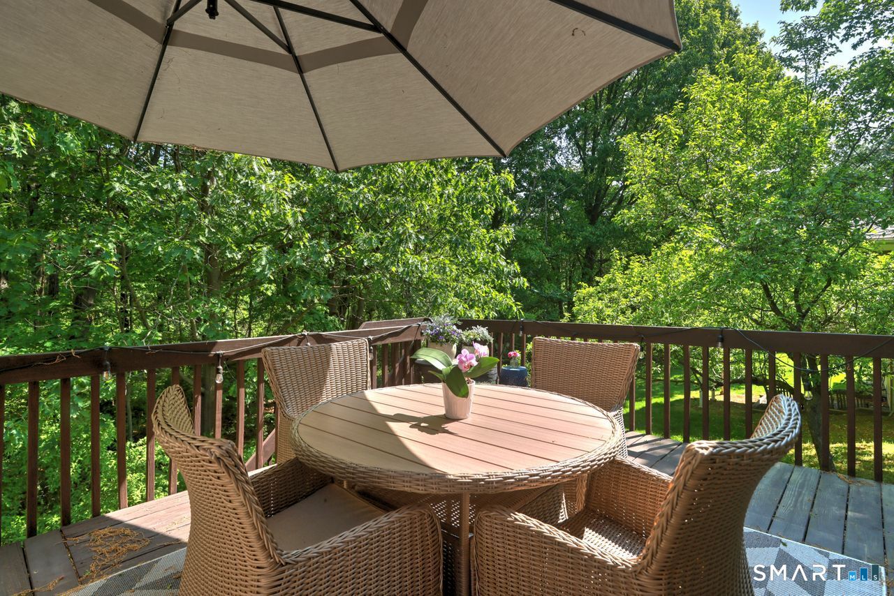 9 Canterbury Road, Unit 9 Hamden, CT 06514 - Photo 14 of 29 a view of a balcony with furniture and umbrella